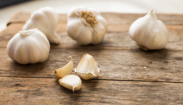 istock Garlic cloves on wooden vintage background. 674615896