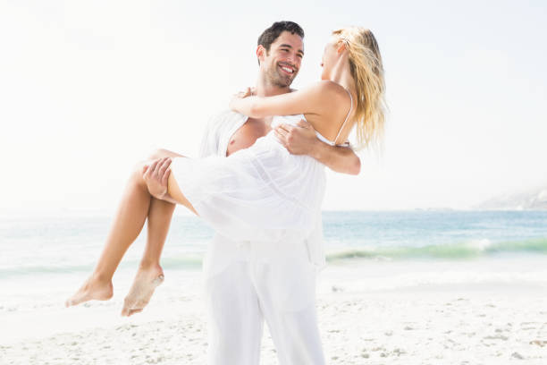 istock Boyfriend carrying girlfriend on the beach 674617150