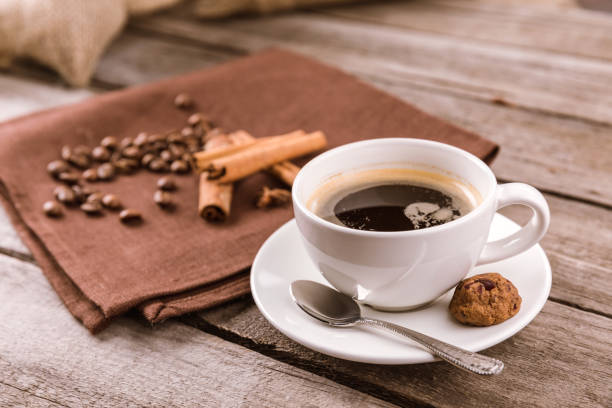 istock side view of coffee mug steam and cinnamon sticks on napkin 674621224