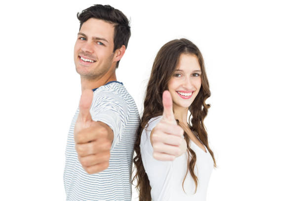 istock Couple standing back to back with thumbs up 674624120