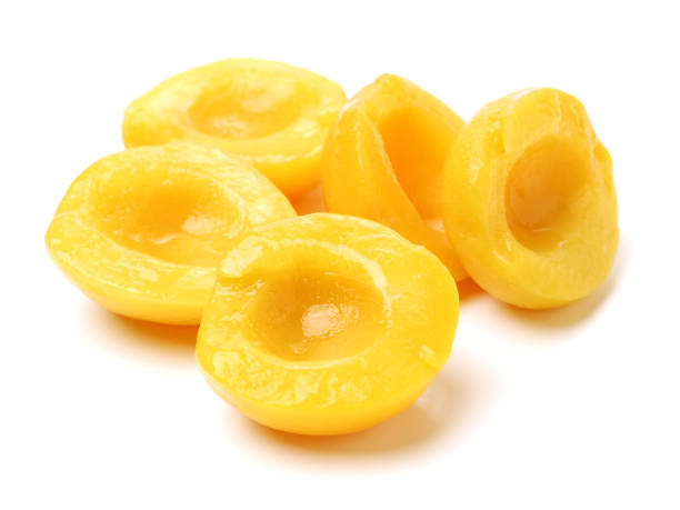 istock Canned peach on syrup over white background 674624634