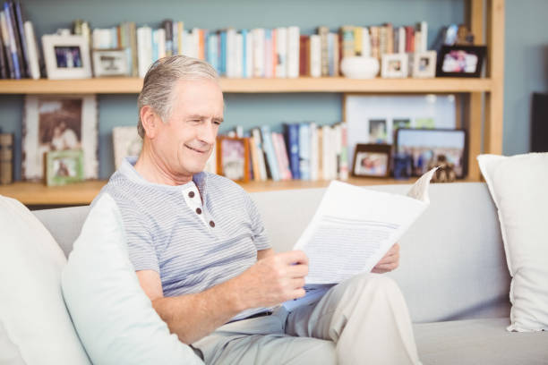 istock Happy senior man reading newspaper 674627762