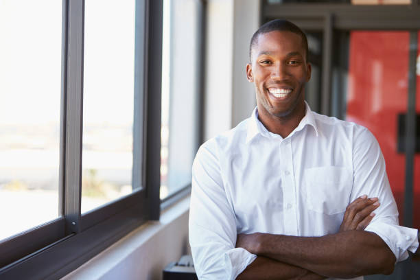 istock Young black man with arms crossed smiling, horizontal 674627868