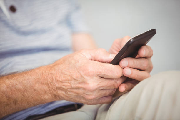 istock Close-up of man using mobile phone 674628052