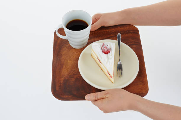 istock Coffee and confectionery on a tray held in hand 674628378