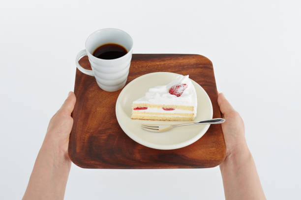 istock Coffee and confectionery on a tray held in hand 674628394