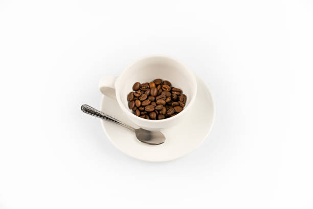 istock coffee beans in coffee mug with spoon  isolated on white 674630652