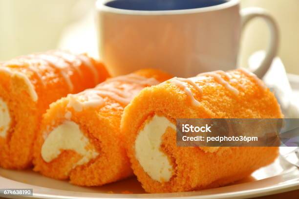 Orange Cake Roll Stuffed Cream With Coffee Stock Photo - Download Image Now - Baked, Bakery, Bun - Bread