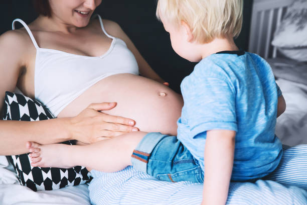 istock Pregnant mother and son at home. 674639092