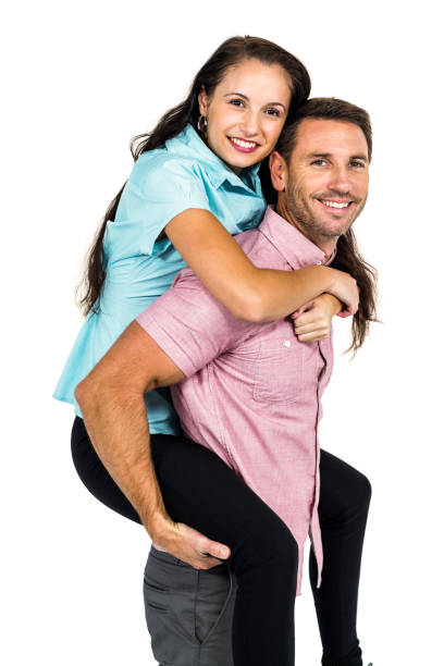 istock Smiling man carrying his girlfriend on back 674639144