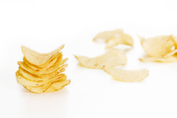 istock Crispy potato chips isolated on white background  close-up 674639378