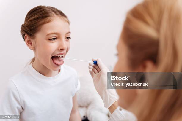 Competent Doctor Examining Her Little Patient Stock Photo - Download Image Now - Adult, Advice, Care