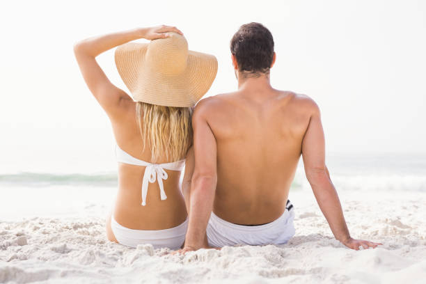 Happy couple sitting on the beach