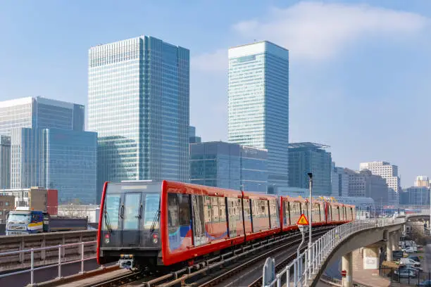 Docklands light railway in London with Canary Wharf in the background