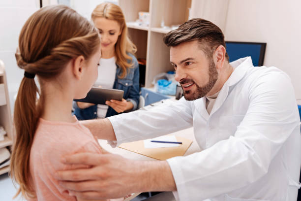 istock Attentive young pediatrician examining his patient 674644084