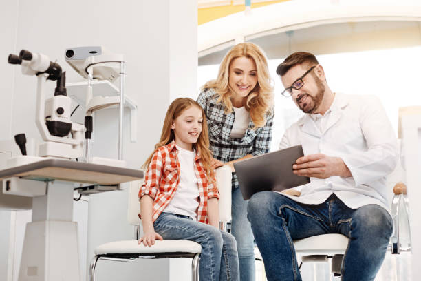 istock Excited cool ophthalmologist telling about patients improvements 674646962