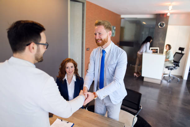 istock Couple talking to loan officer and shaking hands 674647086