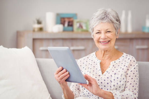 istock Portrait of senior woman using digital tablet 674656632