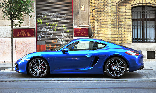 Budapest, Hungary - May 20, 2016: Deep blue Porsche sport car in the street of Budapest on May 20, 2016. Porsche is a global automobile manufacturer headquartered in Stuttgart, Germany.