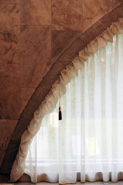 istock Transparent curtain closing a round window 674667360