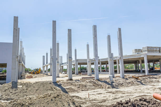 istock Concrete pillars of new edifice with a beautiful sky are placed on sandy ground 674667554