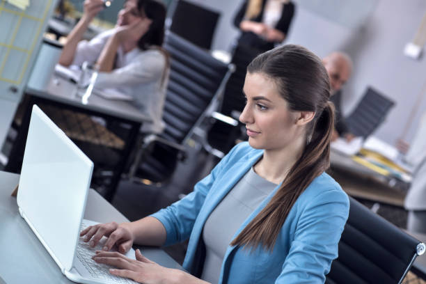 istock Hardworking businesswoman working on a laptop in a modern office 674671824