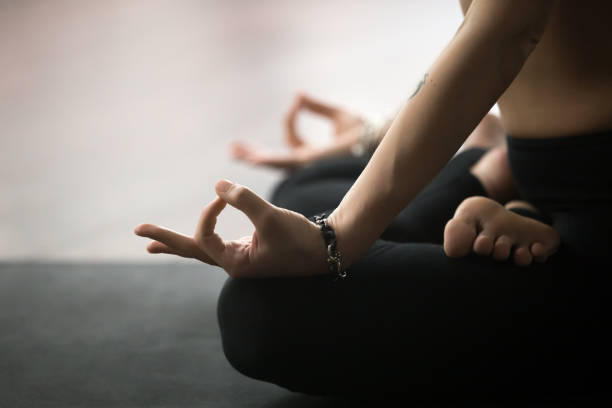 istock Young woman in Lotus pose with mudra gesture, studio background 674673982