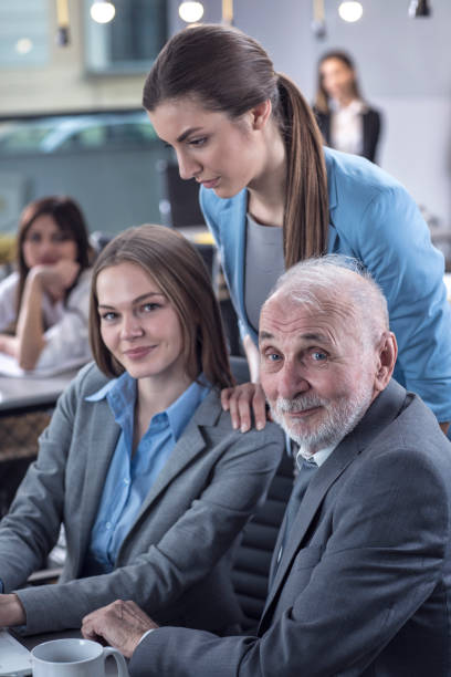 istock Group of businesspeople working together on a laptop 674675648