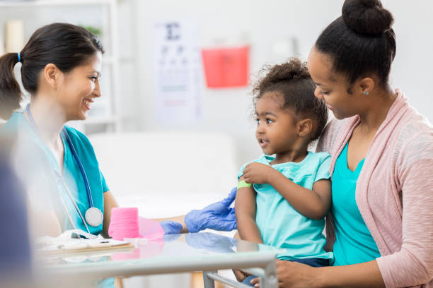 istock Pediatric nurse puts bandage on young patient's arm 674688326
