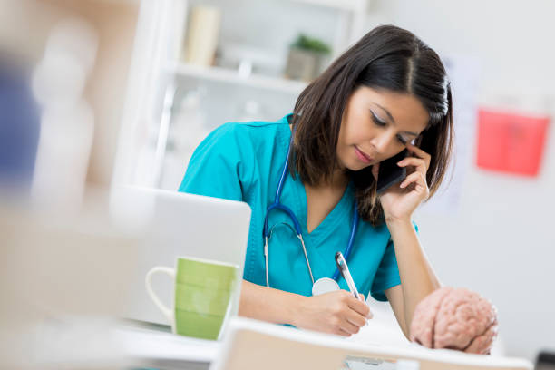 istock Doctor concentrates while talking on the phone 674688330