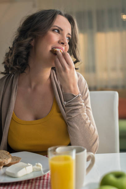 istock Woman eating bread with cream cheese 674695090