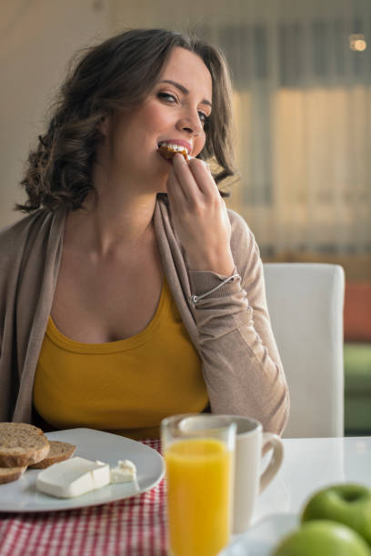 istock Woman eating bread with cream cheese 674695242