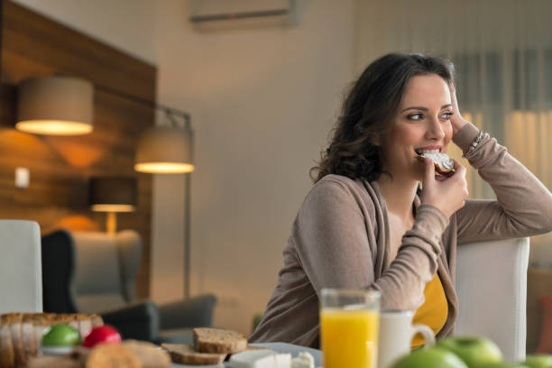 istock Woman eating bread with cream cheese 674695308
