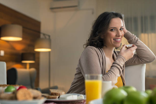 istock Woman eating bread with cream cheese 674697826