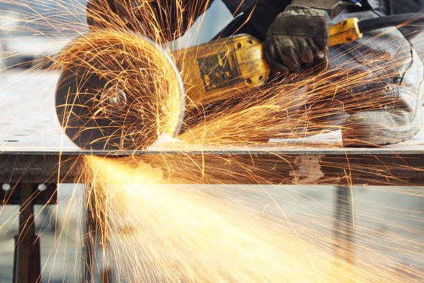 cutting metal Metal worker cutting a metal objects with circular saw in large workshop. serrated stock pictures, royalty-free photos & images