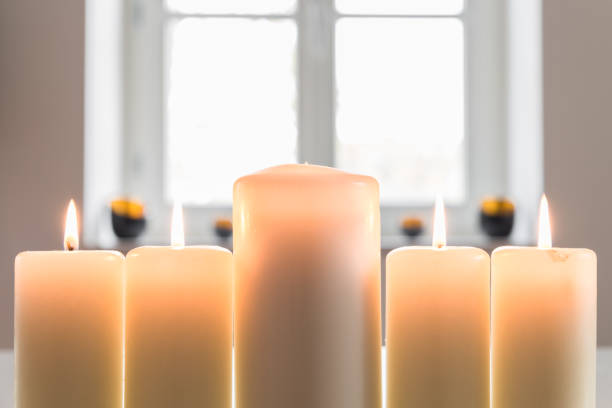 istock Closeup of a white burning candles 674701212