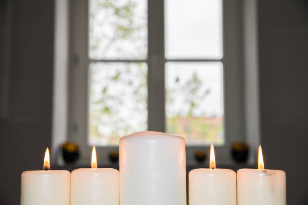 istock Closeup of a white burning candles 674701350