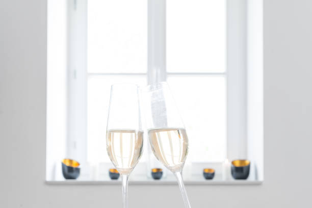istock Two glasses filled with champagne with white background 674704786