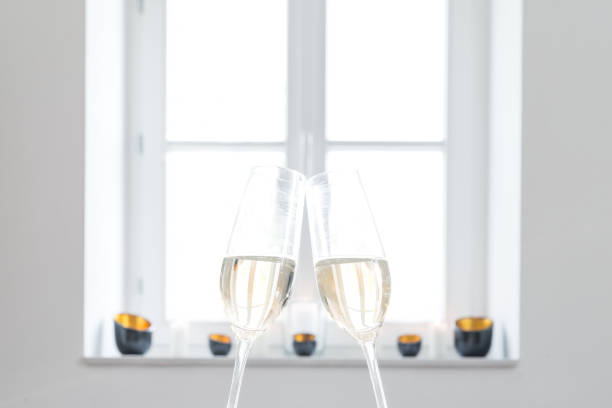 istock Two glasses filled with champagne with white background 674705162