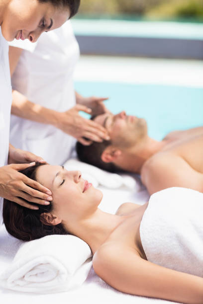istock Couple receiving a head massage from masseur 674705568