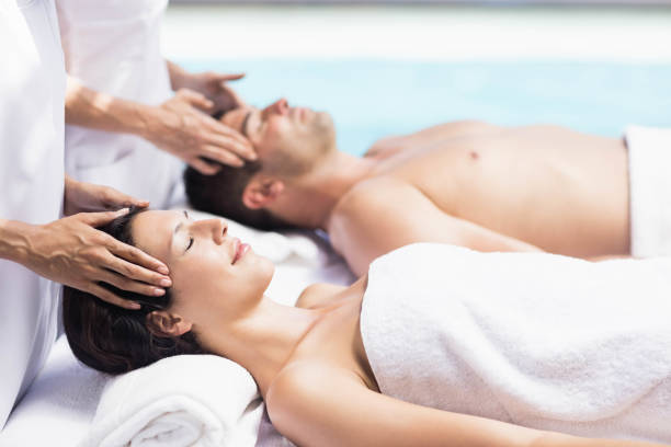 istock Couple receiving a head massage from masseur 674705596