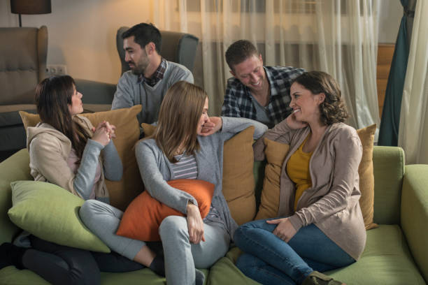 istock Group of friends sitting and talking on sofa at home 674708622