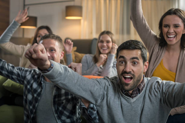 istock Friends watching game on television 674708828