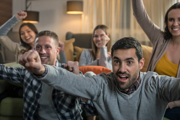 istock Friends watching game on television 674710910