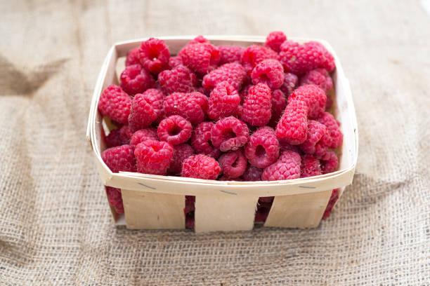 istock Fresh raspberries in a village basket 674711052