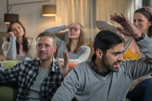 istock Friends watching game on television 674711168