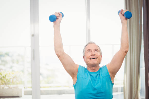 istock Senior man holding dumbbells 674711802