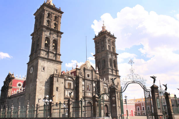 Villahermosa, Mexico. April 4th, 2025. Old houses at Saenz St., a pedestrian area in downtown Villahermosa with memorial for the bicentennial independence celebration in the background.