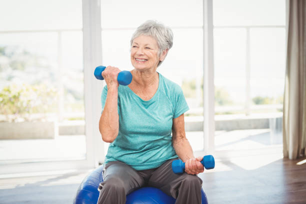 istock Smiling senior woman holding dumbbell 674714248