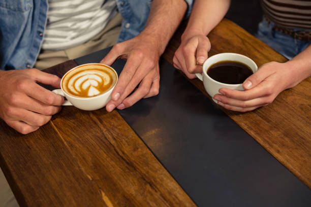 istock Close-up of couple holding coffee 674729876
